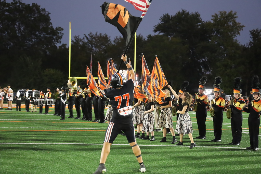 Football player holding W and American Flag