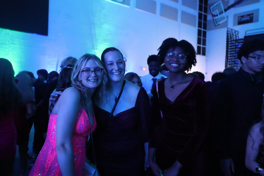 Three students smiling and posing 