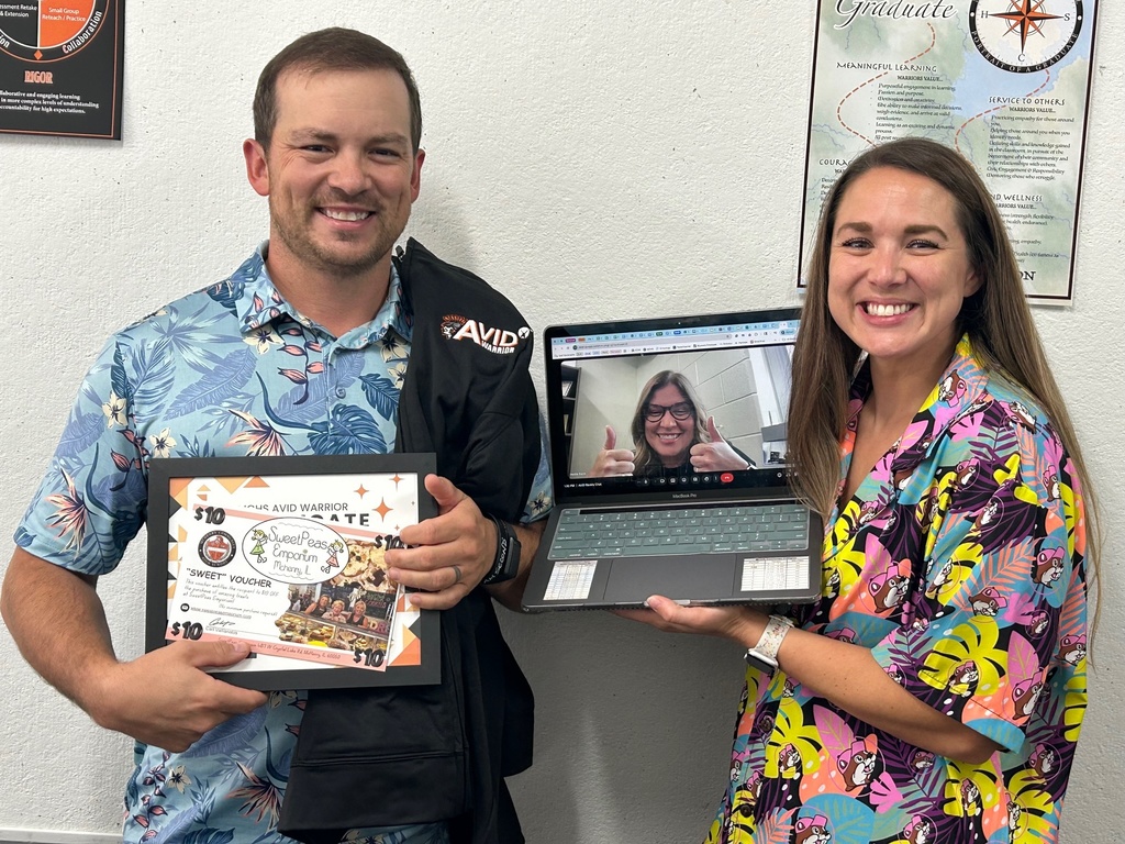 Mr. Sterner with certificate. Heidie Dunn on video chat and Lauren Hines holding the laptop