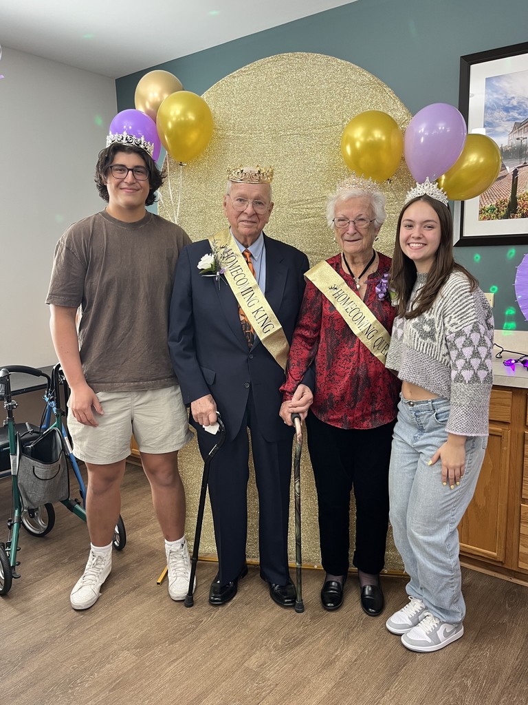 Chase and Kyra with two people at the retirement home wearing sashes and crowns