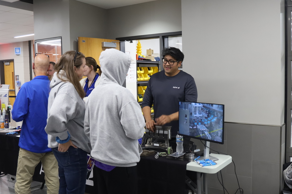 Person at vendor booth talking to a student