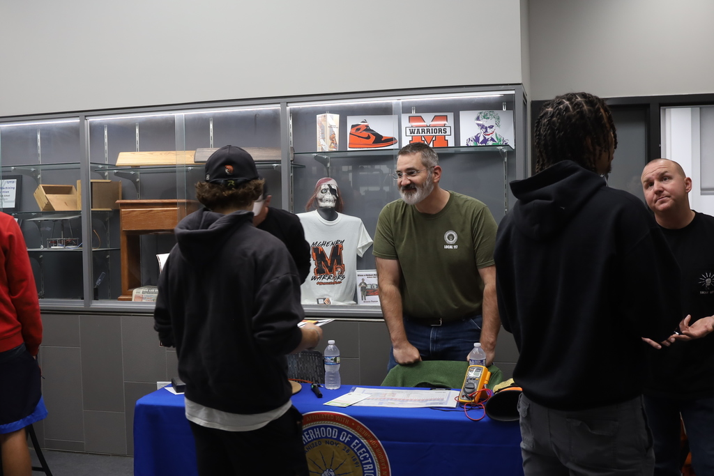 Person at vendor booth talking to a student