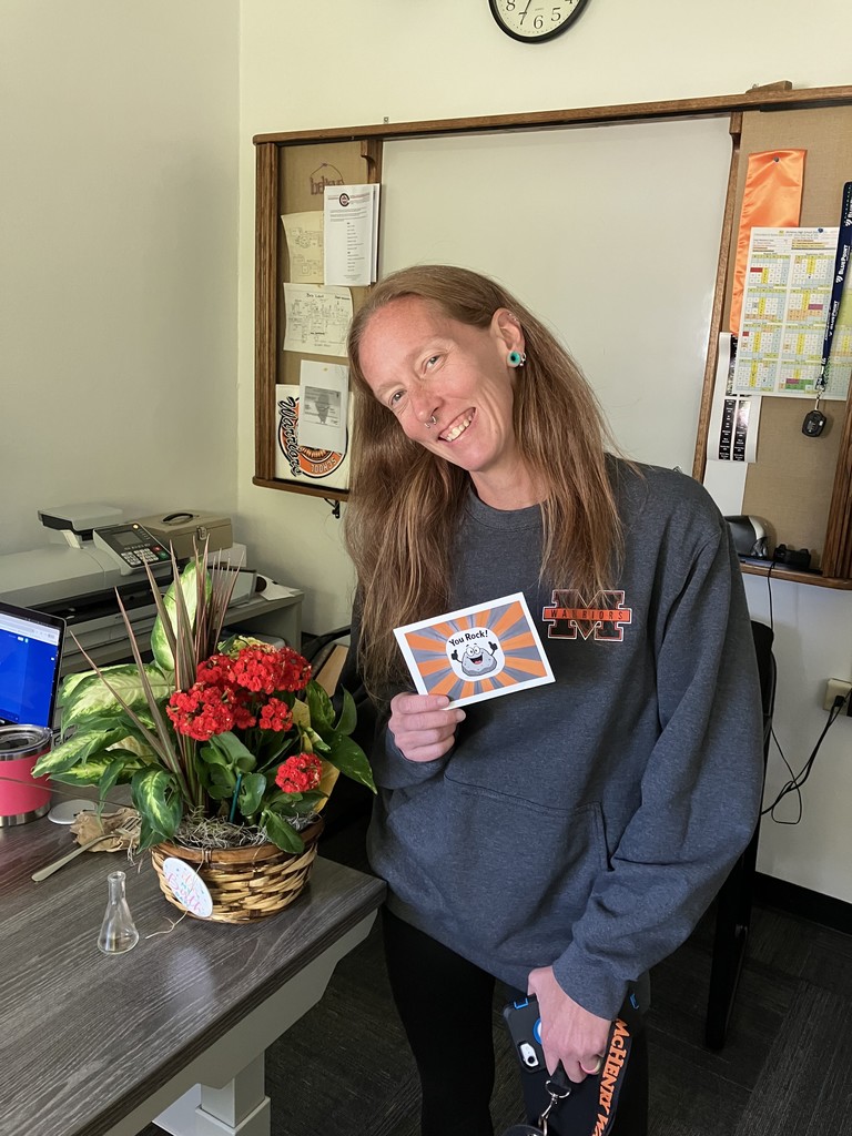 Sasha holding "You rock!" postcard with a rock cartoon