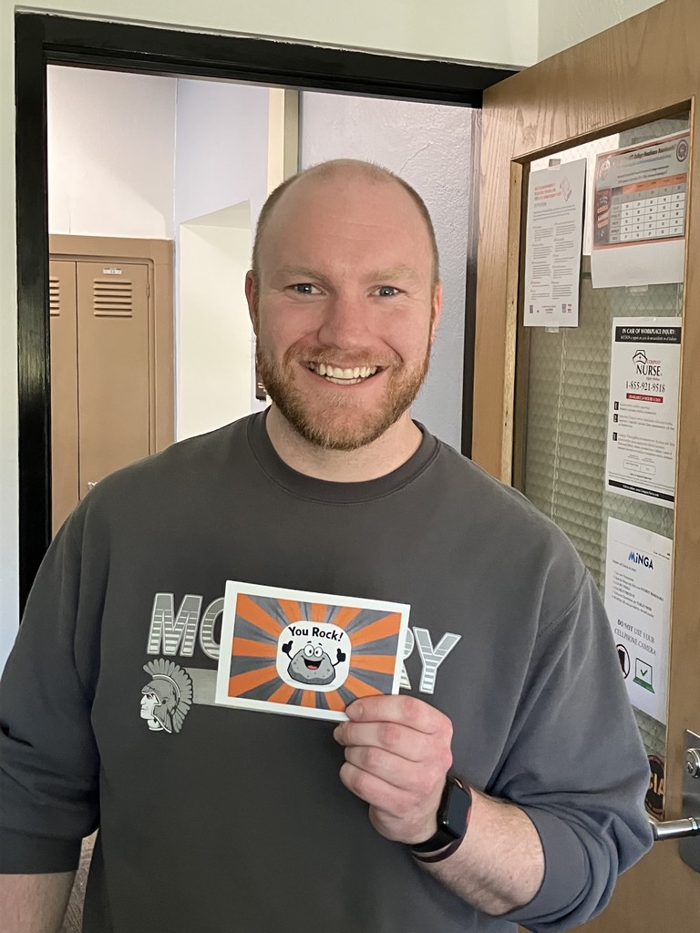 Curlott holding "You rock!" postcard with a rock cartoon