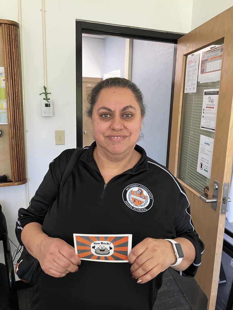 Monica holding "You rock!" postcard with a rock cartoon