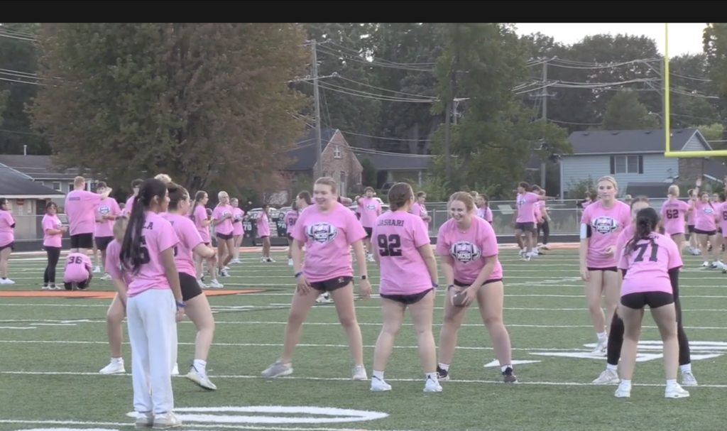 Students in pink playing Powder Puff