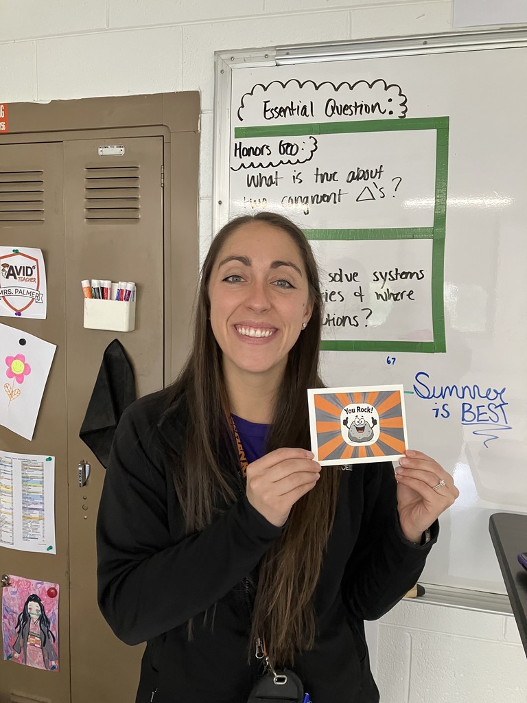 Kaitlin Palmer holding a postcard that says "You Rock