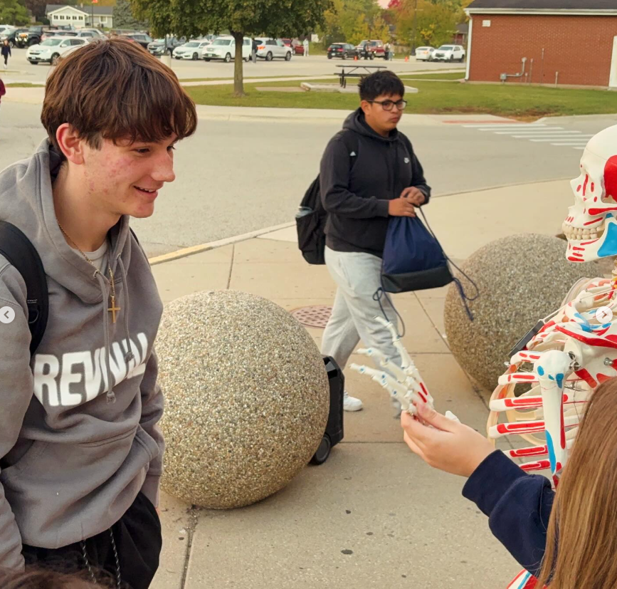 Student smiling at the skeleton