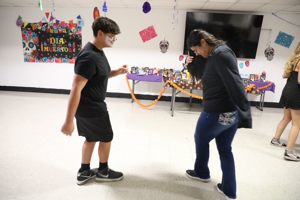 Two students dancing at Day of the Dead Event