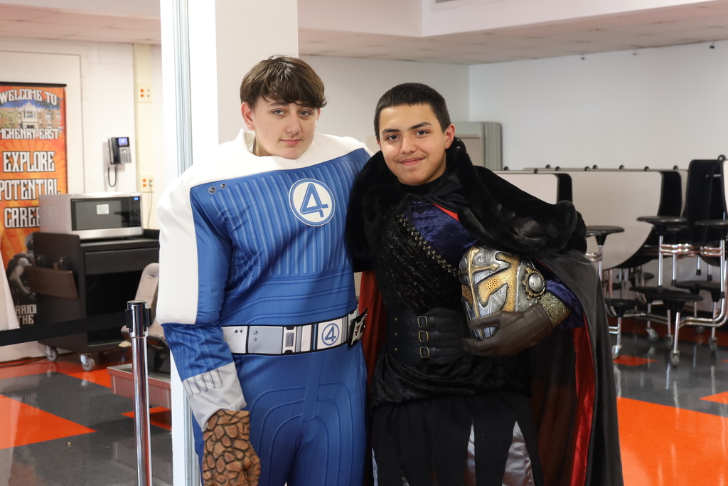 Students in Halloween costumes, blue suit with a four on it, and a medieval costume