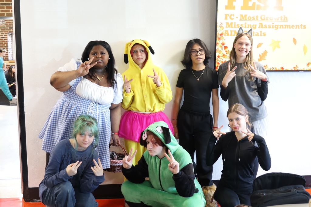 Group of students in costumes, Dorothy, Pikachu, cat, dog