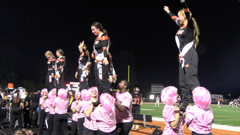 Cheer leaders holding up seniors