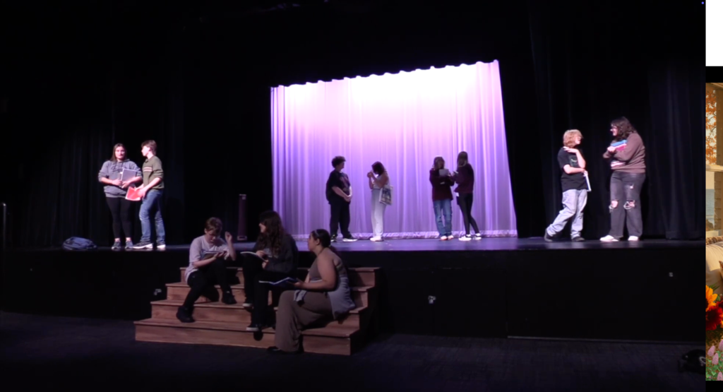 Students practicing on stage for the Freshman Campus play