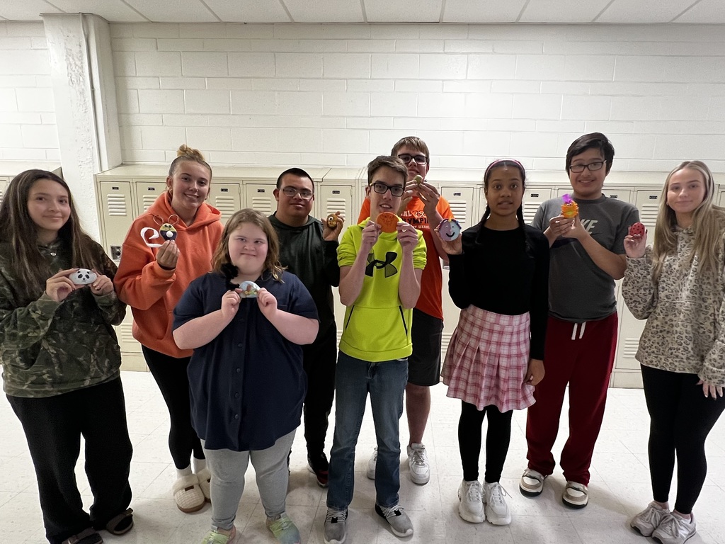 Group of students holding pet rocks