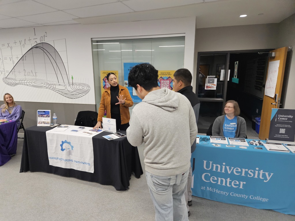 Manufacturing rep talking to two students