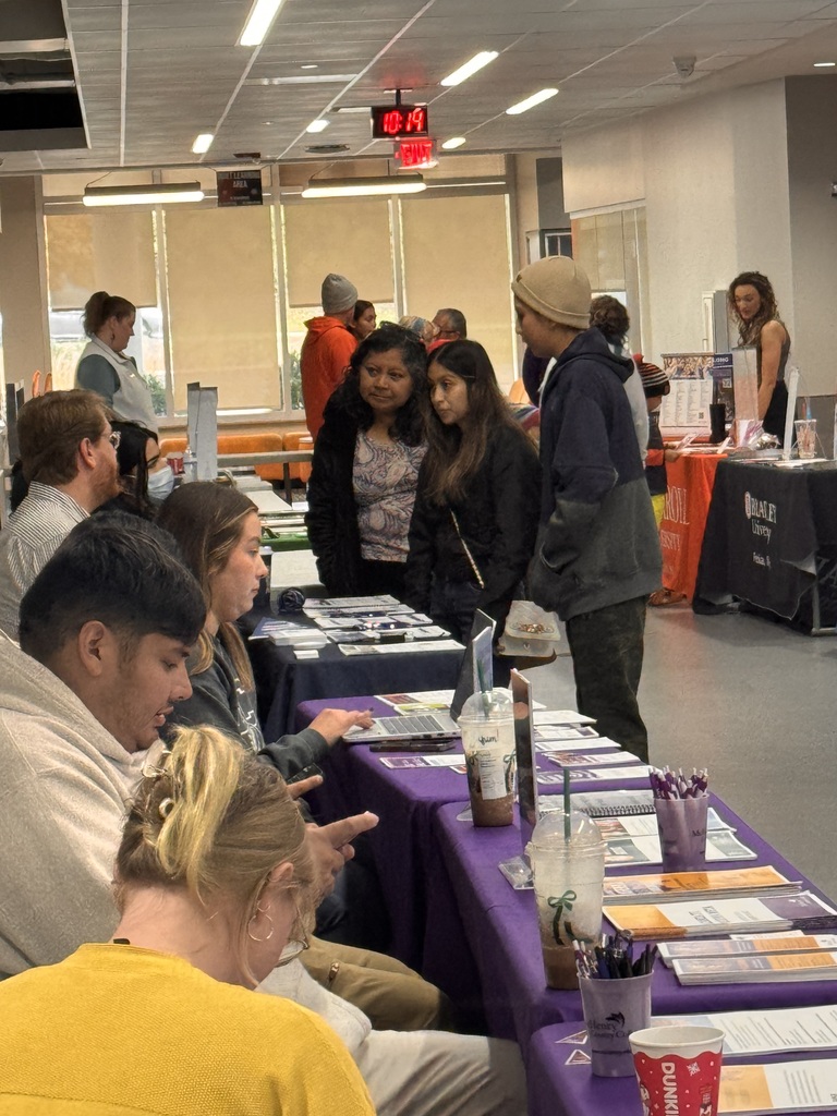 Students and parent talking to college reps