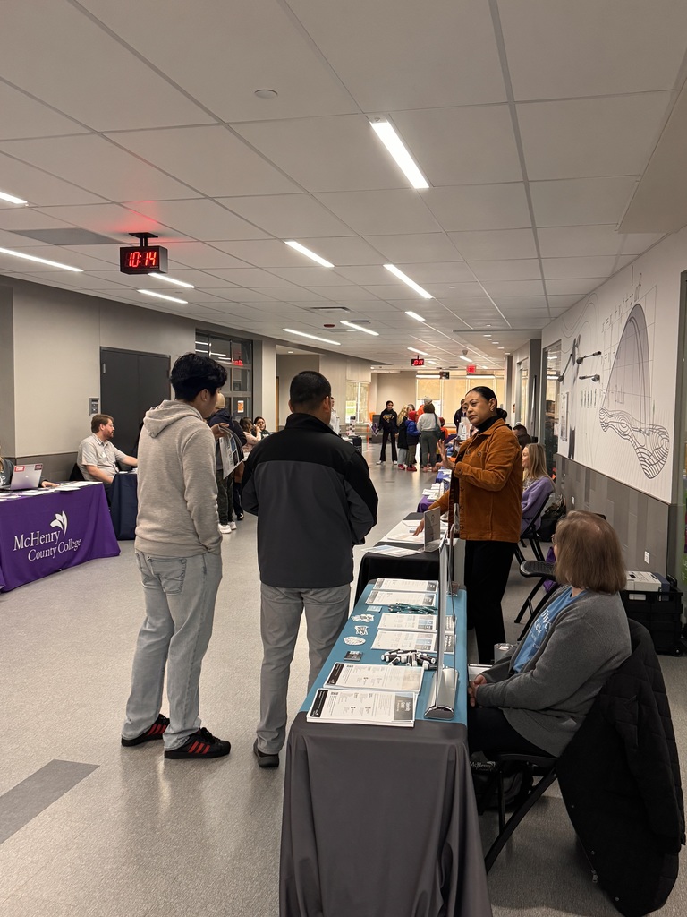 Two students talking to a college reps