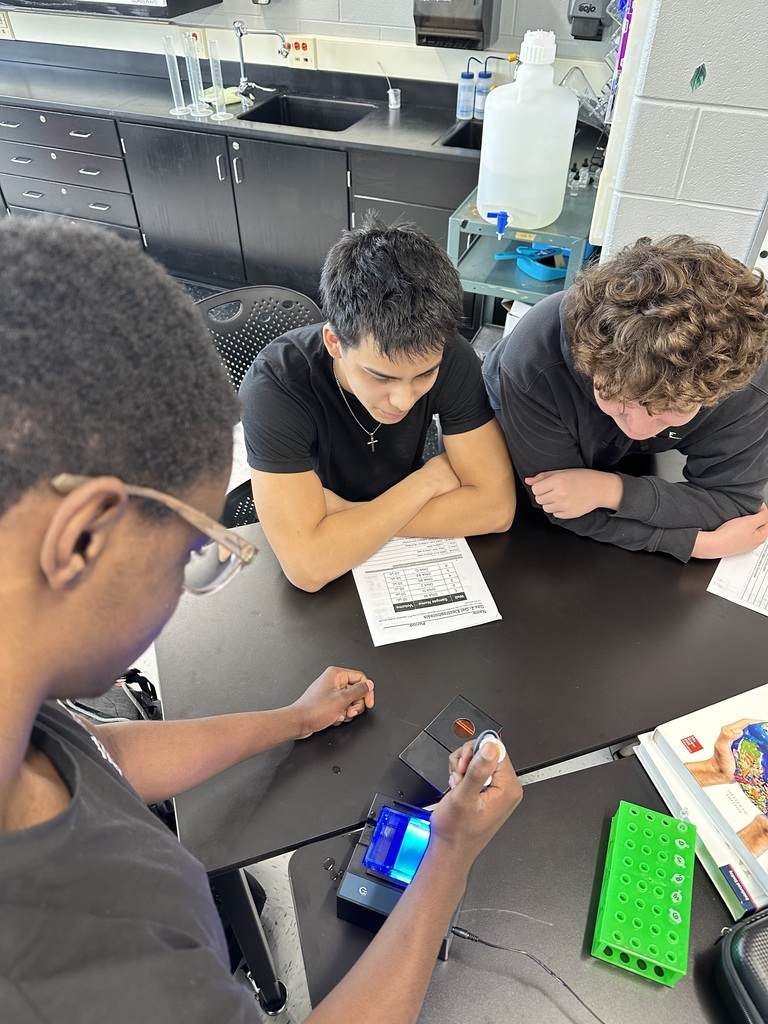 Three students working on a DNA lab in biology 