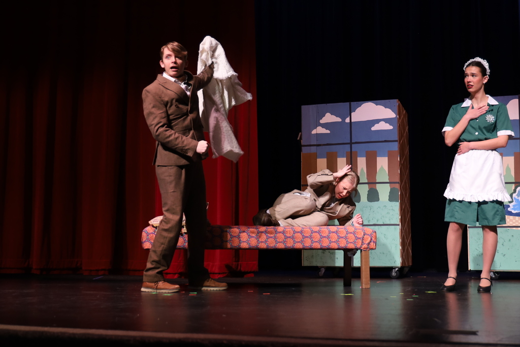 Character revealing other character under blanket maid looking shocked