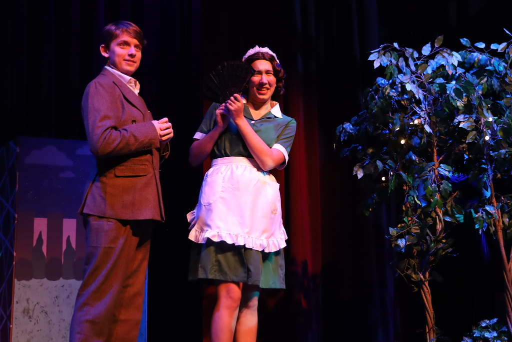 Character hiding behind a fan from other character