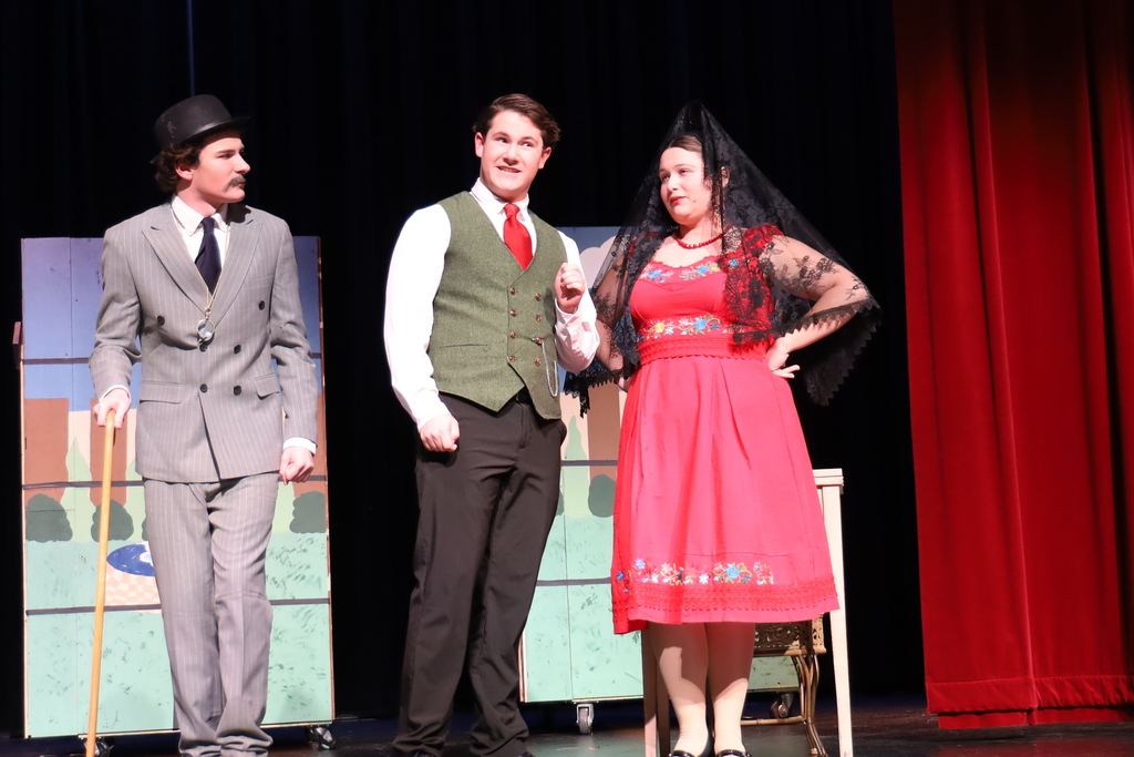 Old man character, man character and woman character on stage