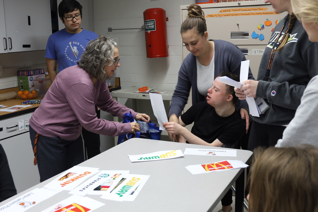 Student reaching for bag