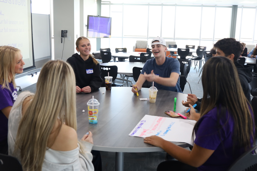 Students working on writing things down at a table