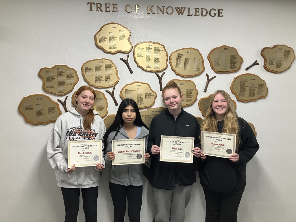 Four students of the month with certificates