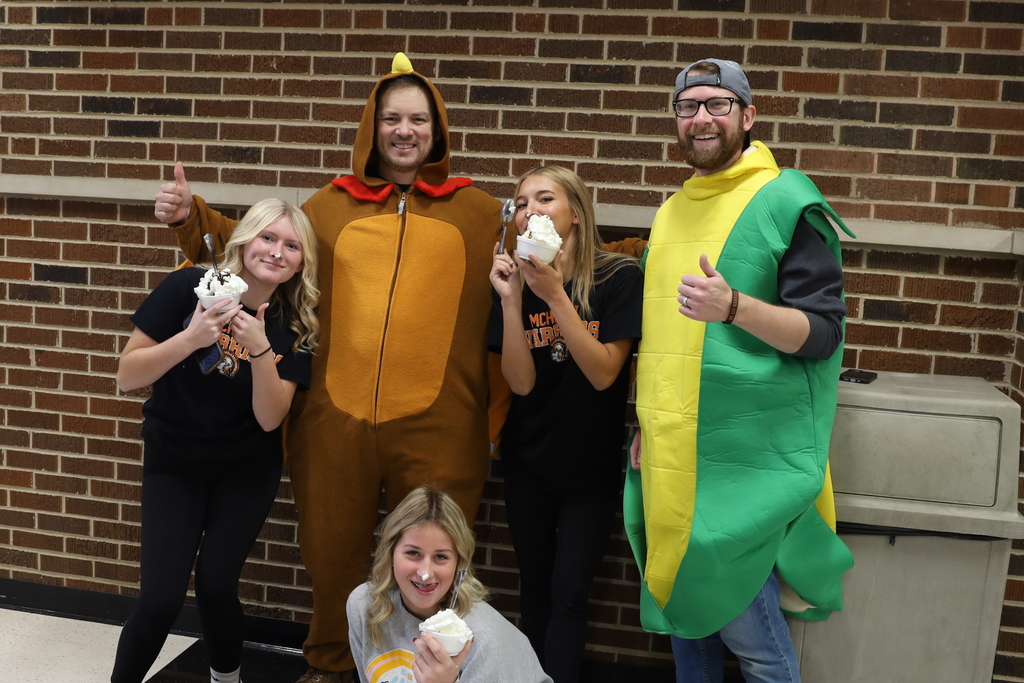 Staff dressed as turkey and corn around students