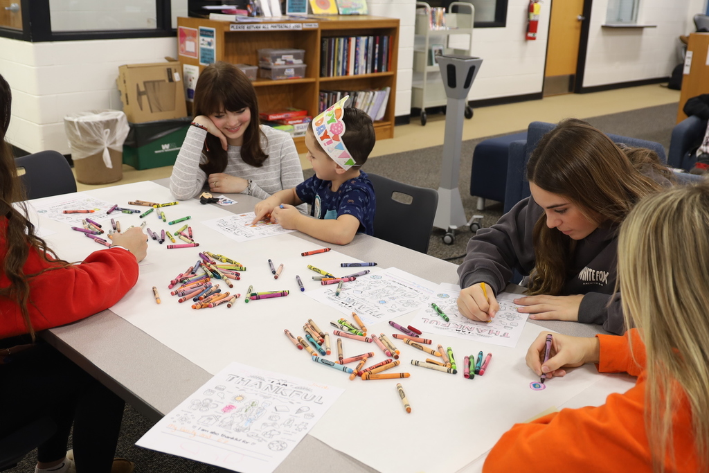 High Schoolers coloring with the preschoolers