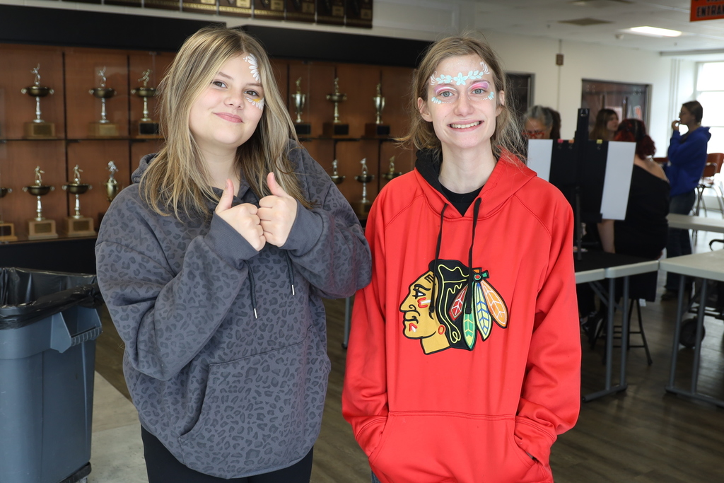 Two students with floral painted on their face
