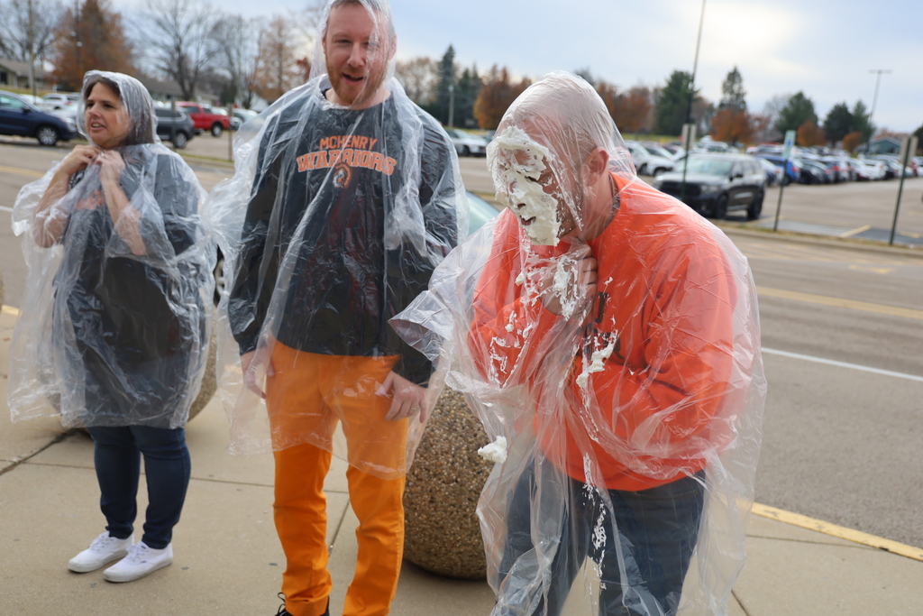 Principal laughing after being pied in the face
