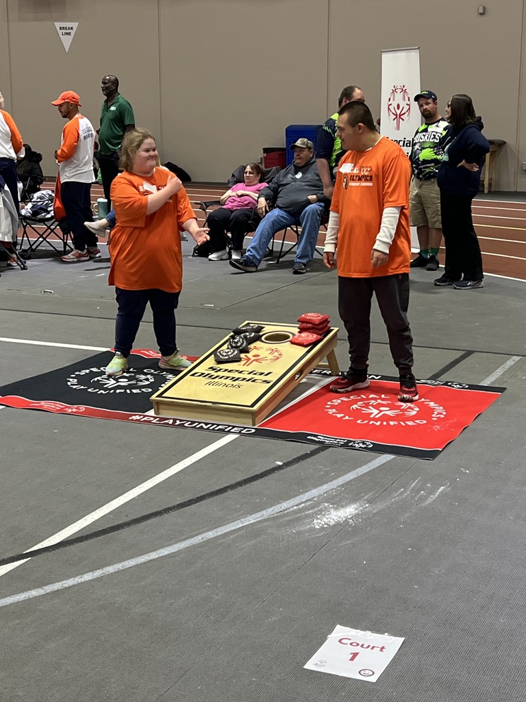 Two students playing cornhole