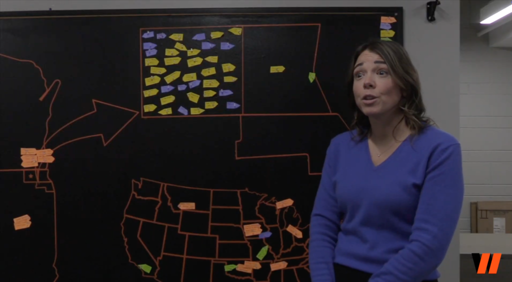 Ms. Schak talking in front of map