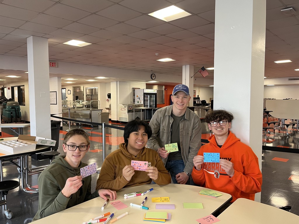 Students holding cards