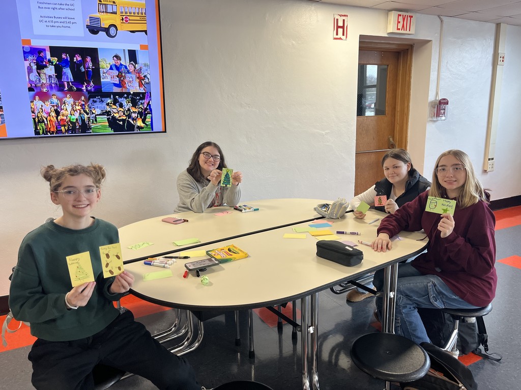 Students holding cards