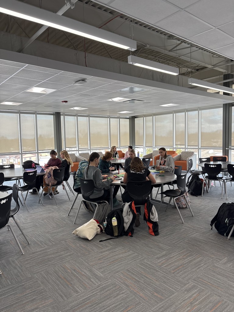 Students at a table making cards