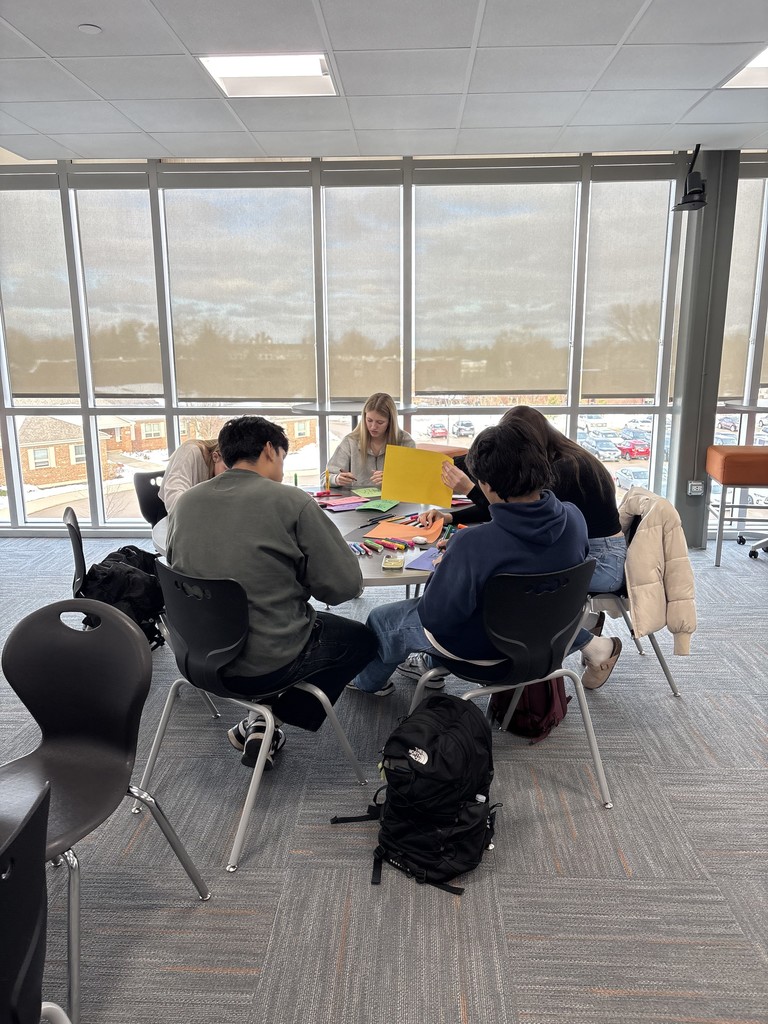Students at a table making cards