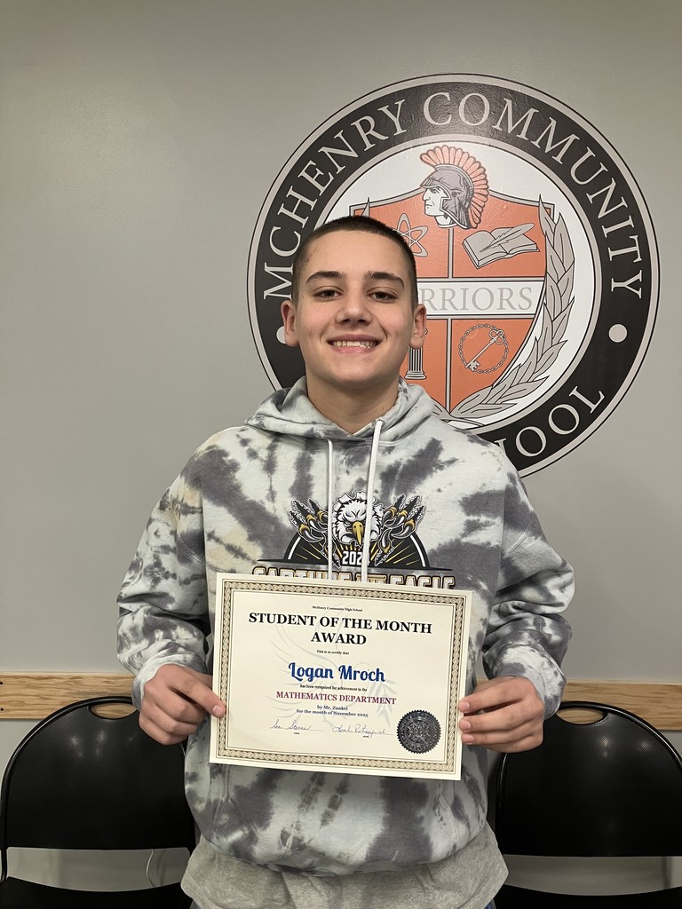 Student holding student of the month award