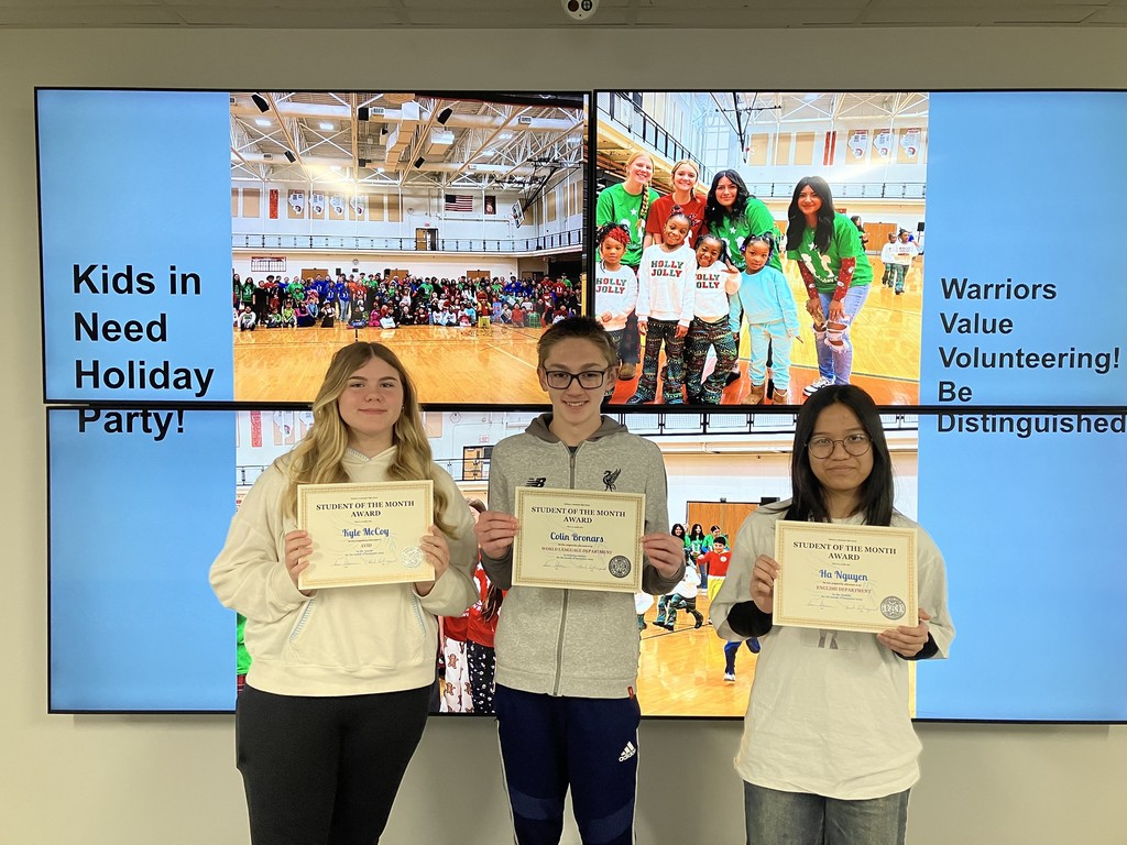 Three students holding student of the month awards