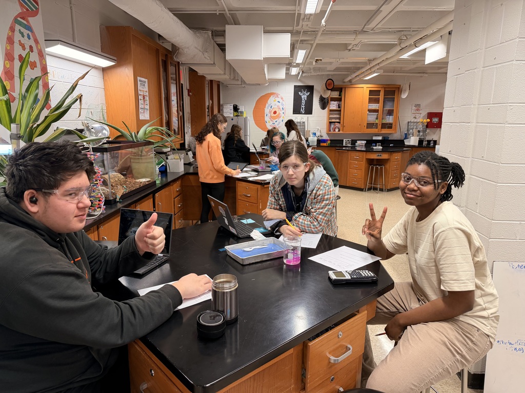Three students at a lab table 