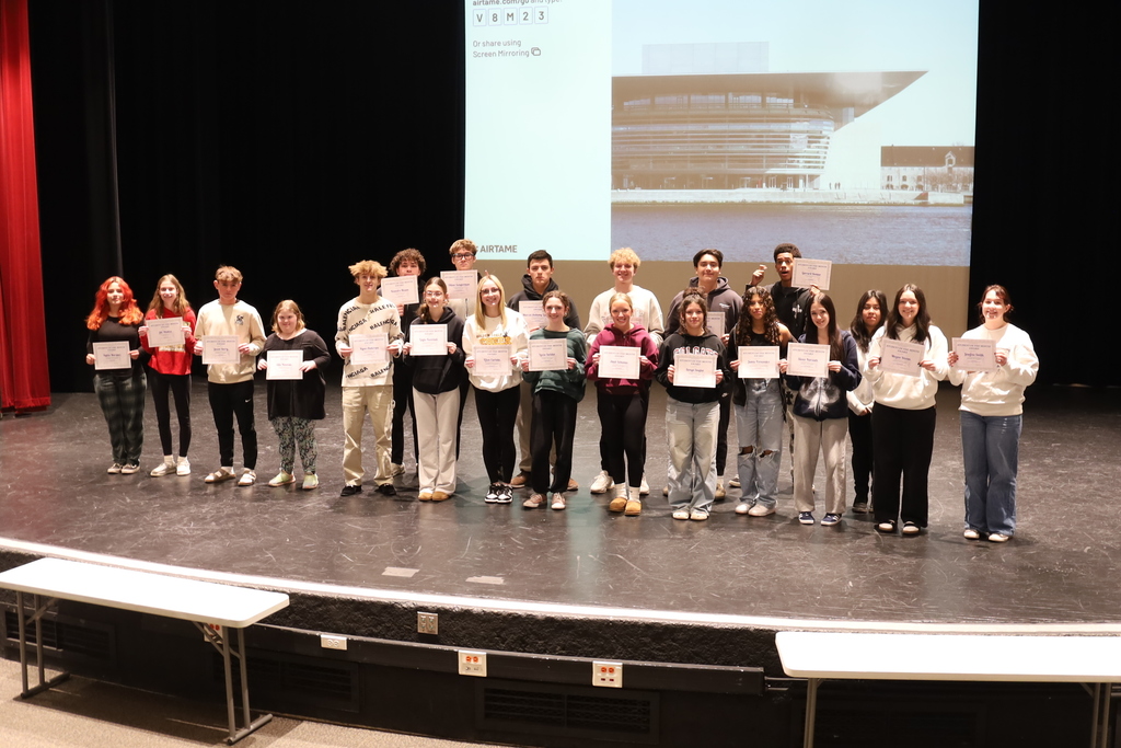 Group photo of Students of the Month on stage with their certificates
