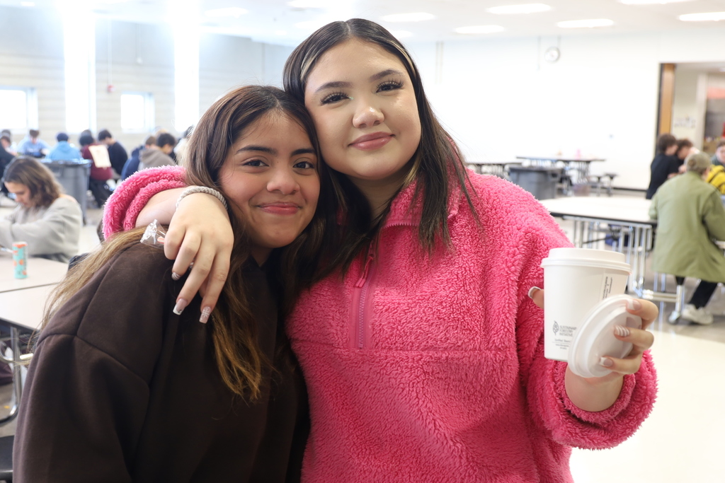 Two students, one with hot chocolate