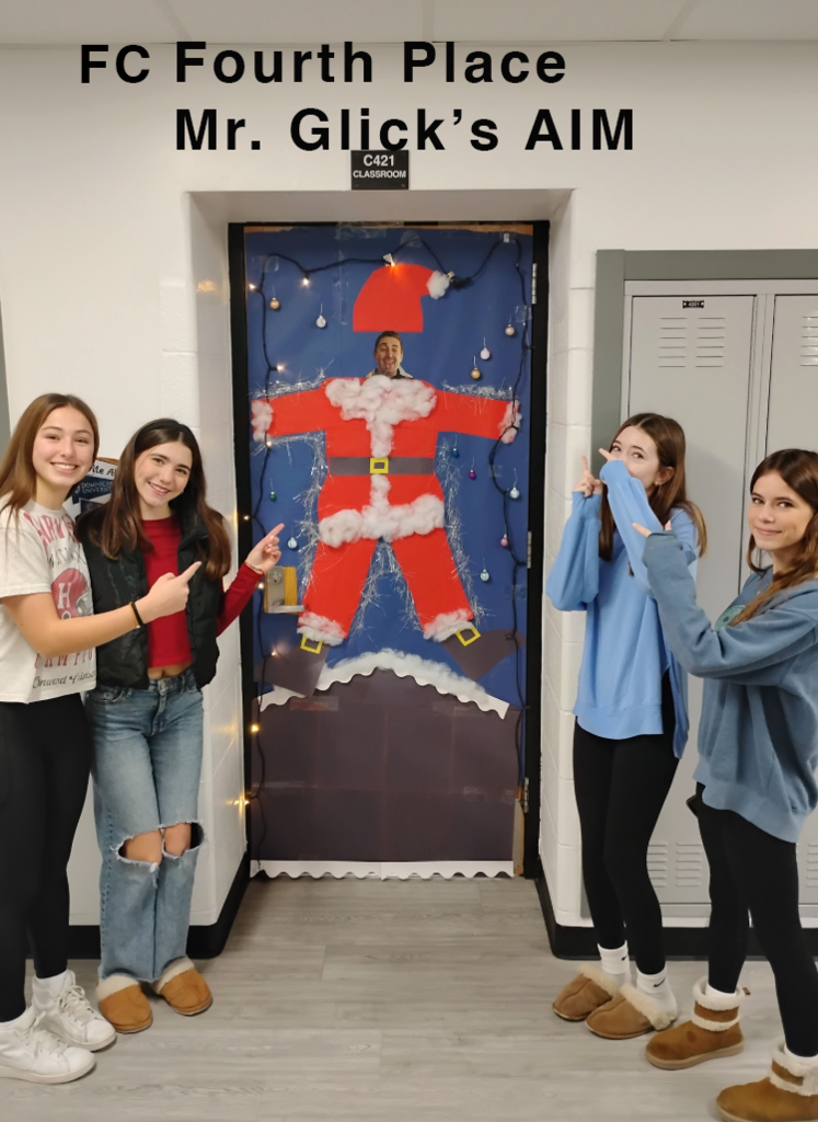 Fourth place Mr. Glick's AIM students by the door with a Santa Outfit and photo of Mr. Glick's face