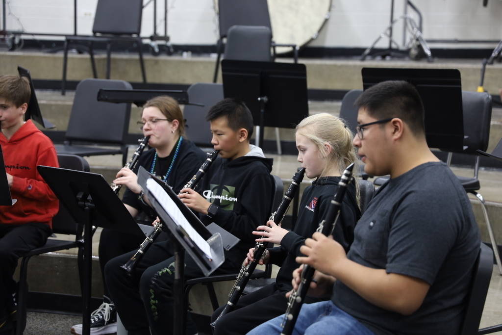High schoolers and middle schooler playing clarinet