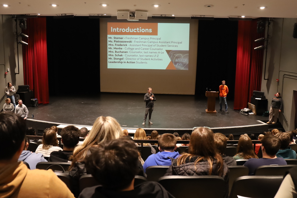 Students watching Principal Sterner in the auditorium 