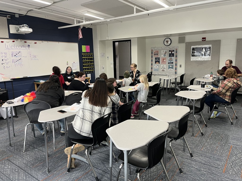 Young students and parent in a classroom
