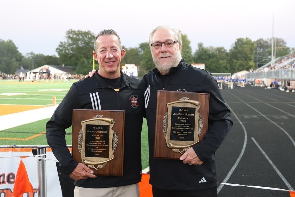 Two Distinguished graduates holding plaques: Michael Christensen and Michael Roberts