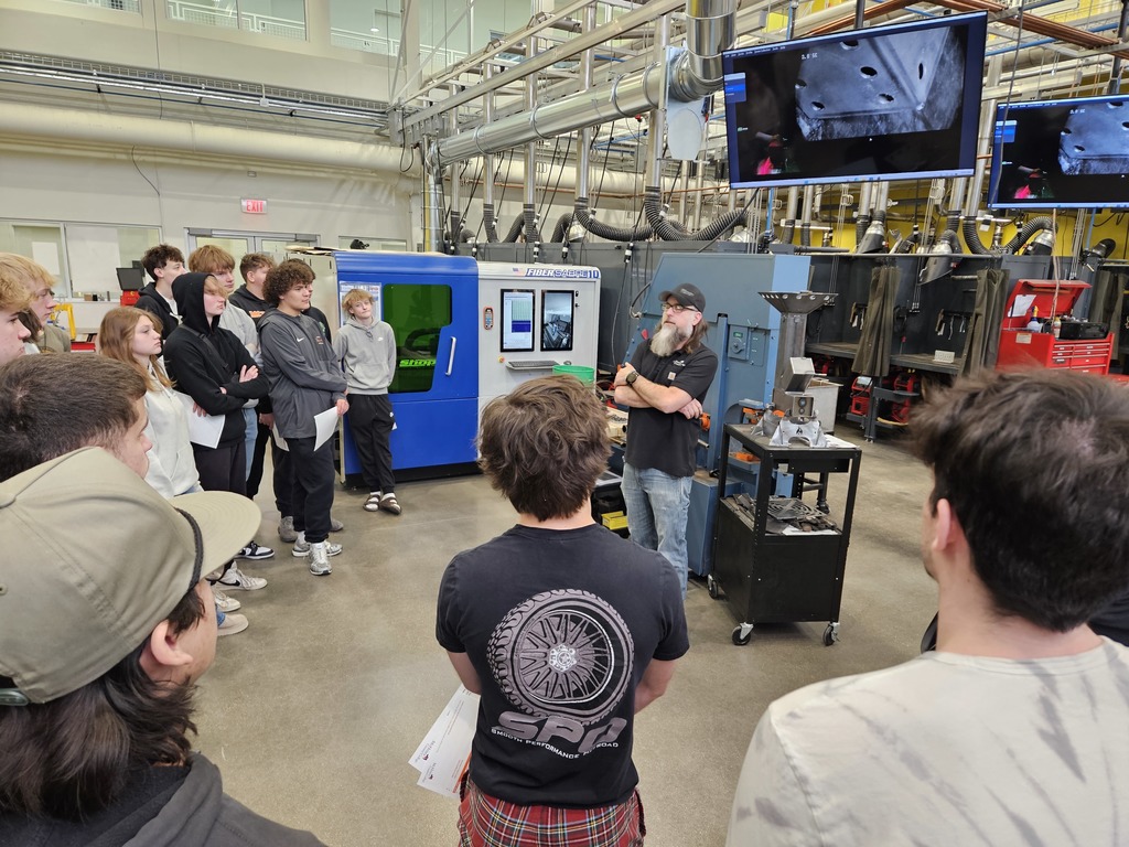 Students in a manufacturing lab around a teacher