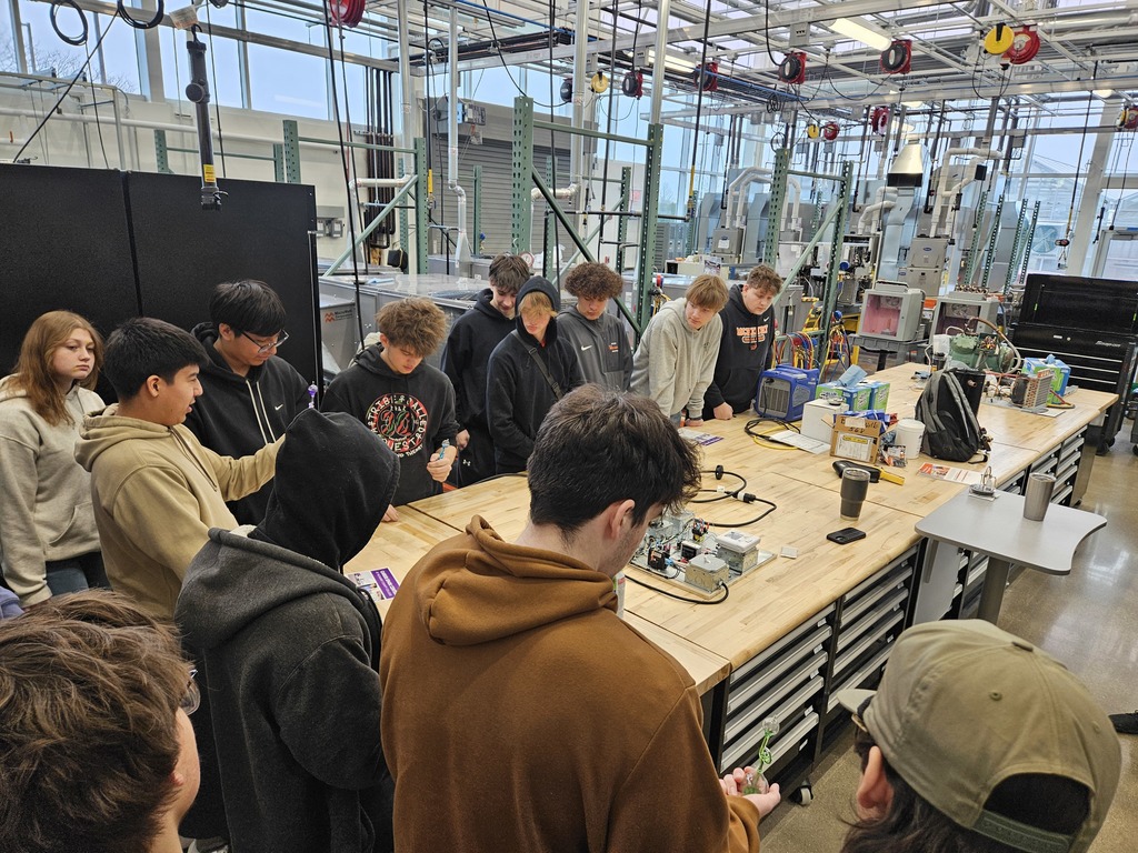 Students in a lab around a table